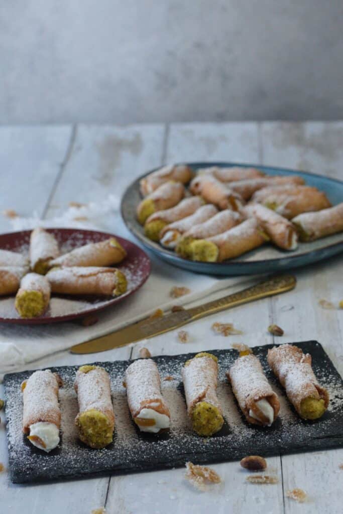 cannoli siciliani served with orange peels and pistachio from Bronte