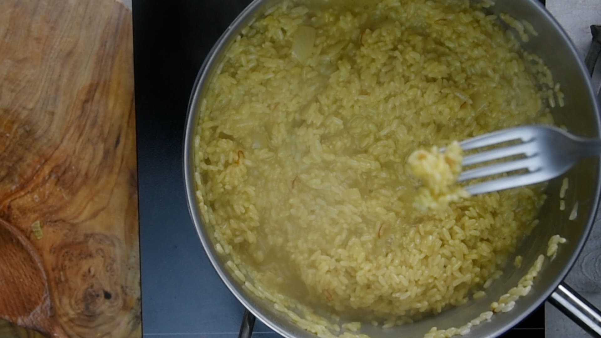 The risotto should be tender on the outside but still have a firm, distinct bite in the center (al dente).