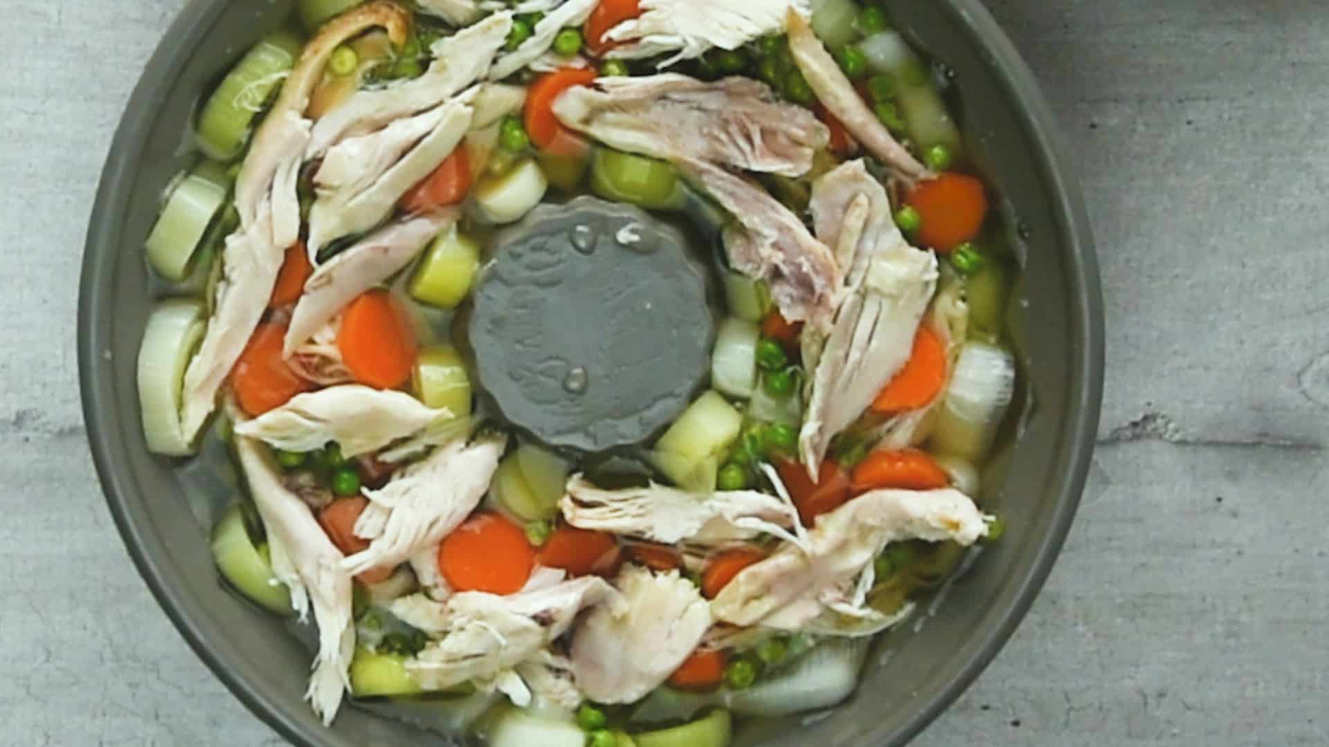 Repeat the process for the last round, adding a mix of chicken, peas, and carrots.