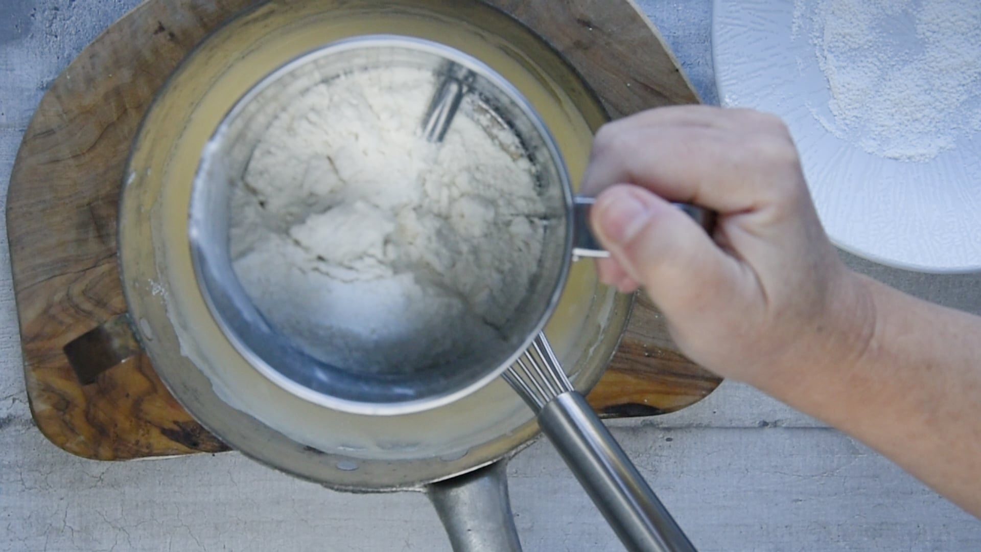 gently fold in the sifted flour, salt, and vanilla essence with a whisk