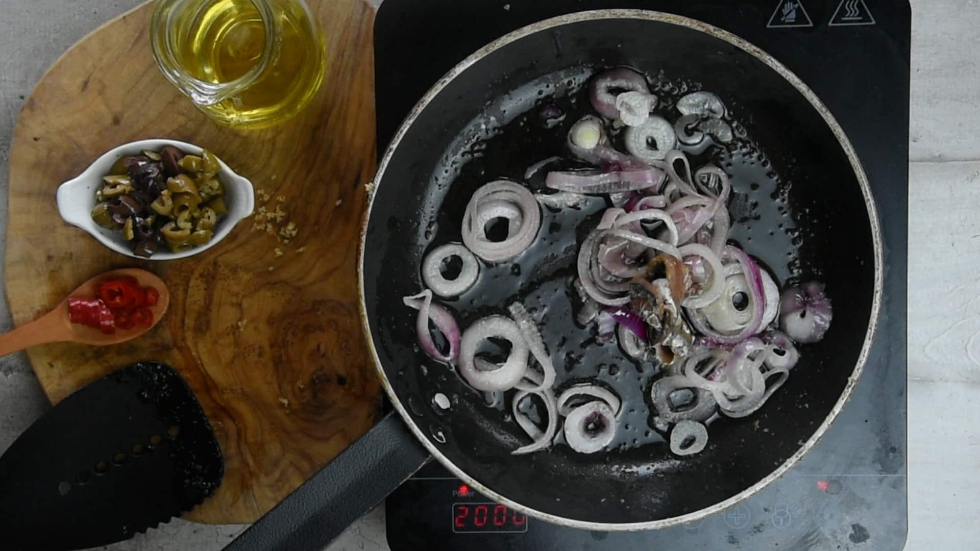 Fry red onions and anchiovies