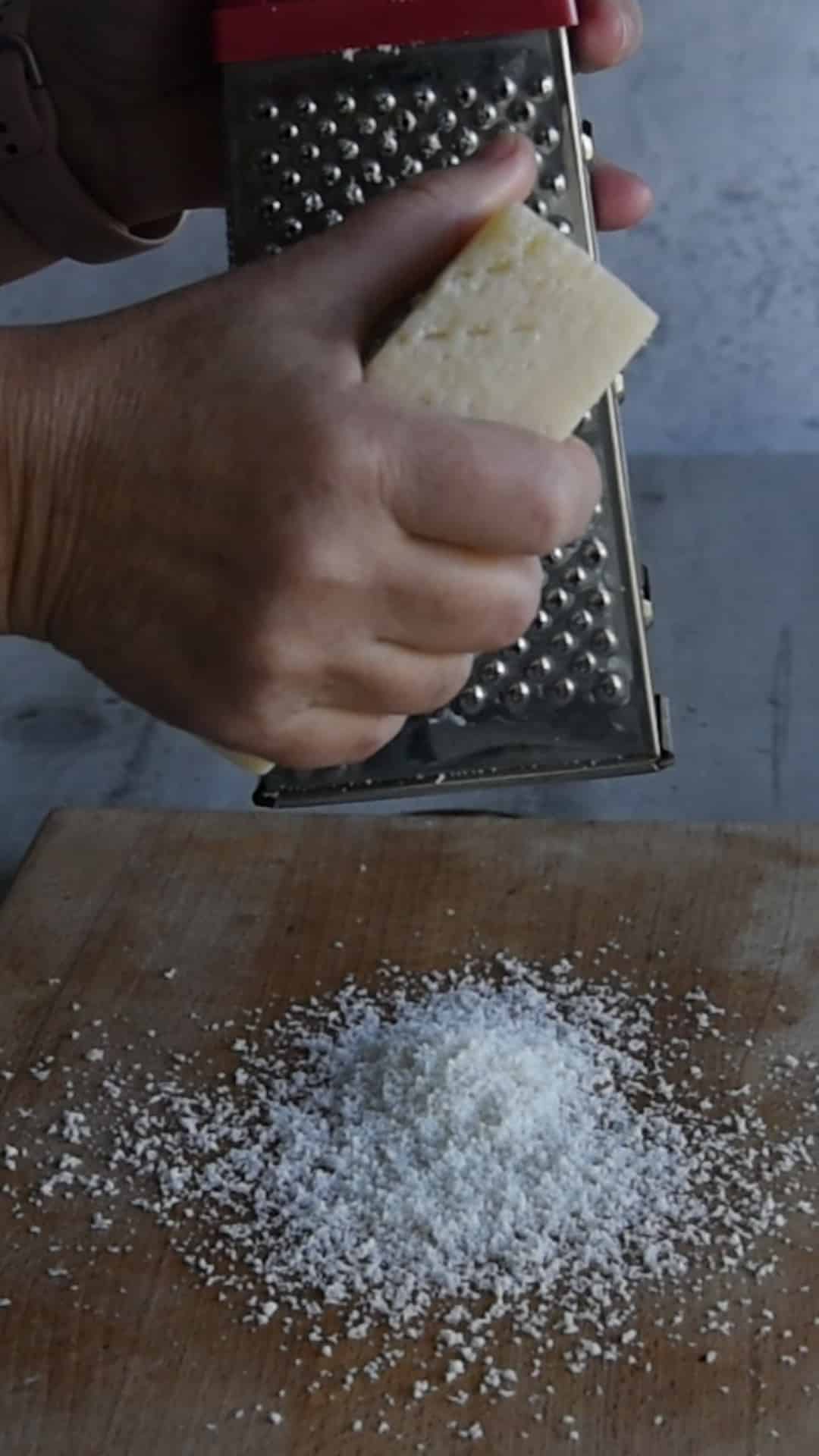 grate the Pecorino Romano using a fine grater to create a light, airy pile.