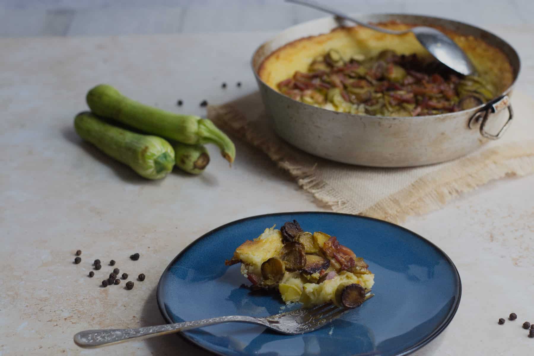 Potato zuccini casserole and a portion served on a plate