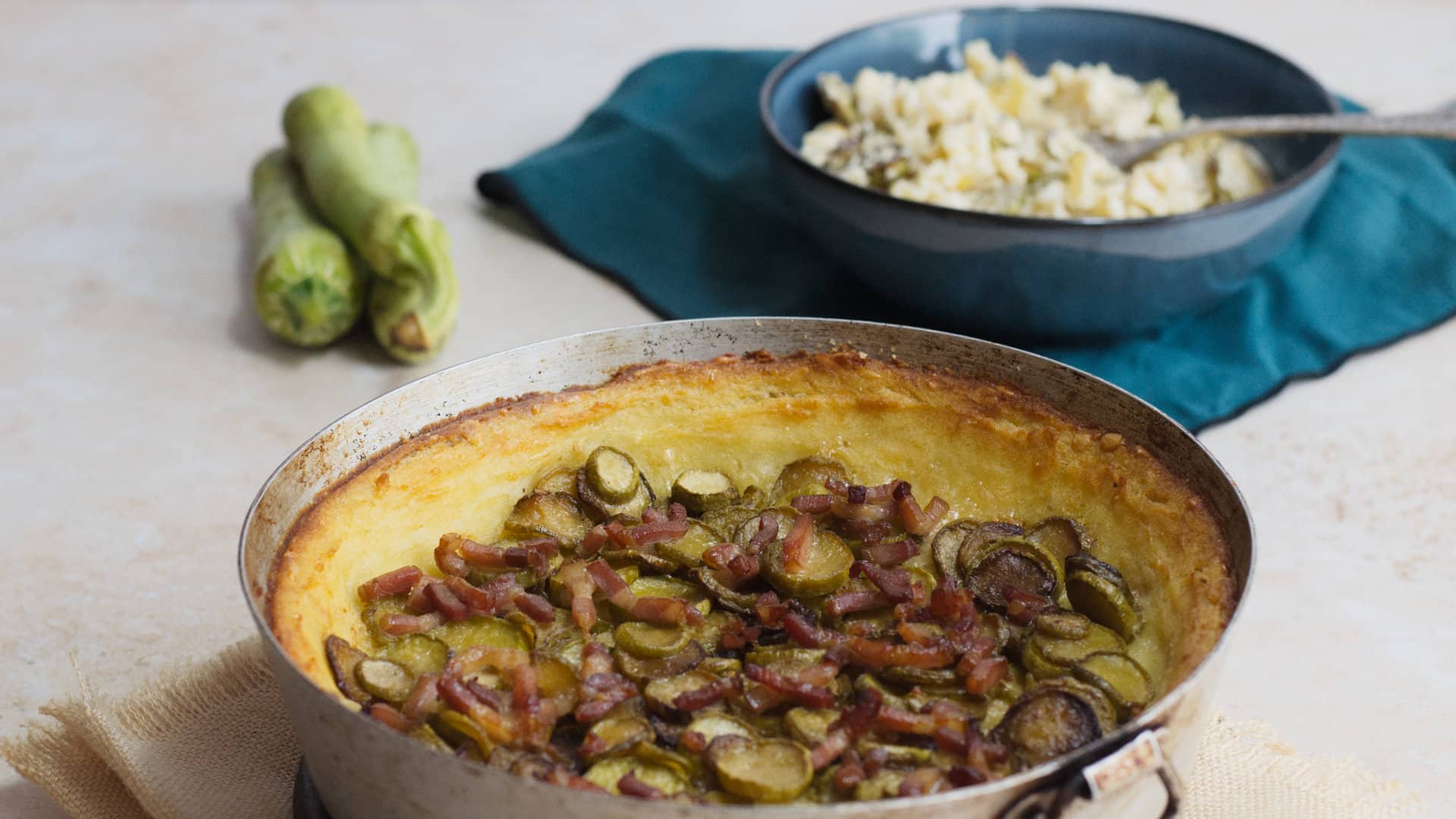 Potato zuccini casserole and pasta with ricotta and zucchini in the background