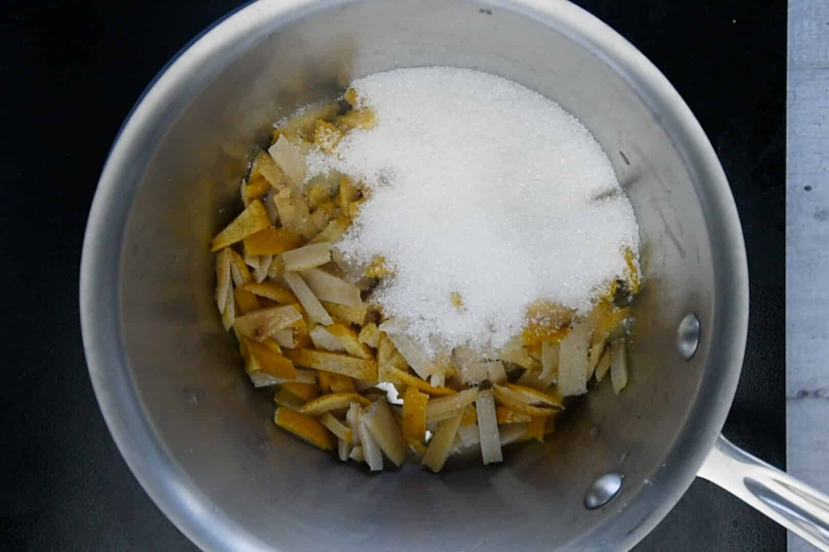 put the peels in a pan with the sugar
